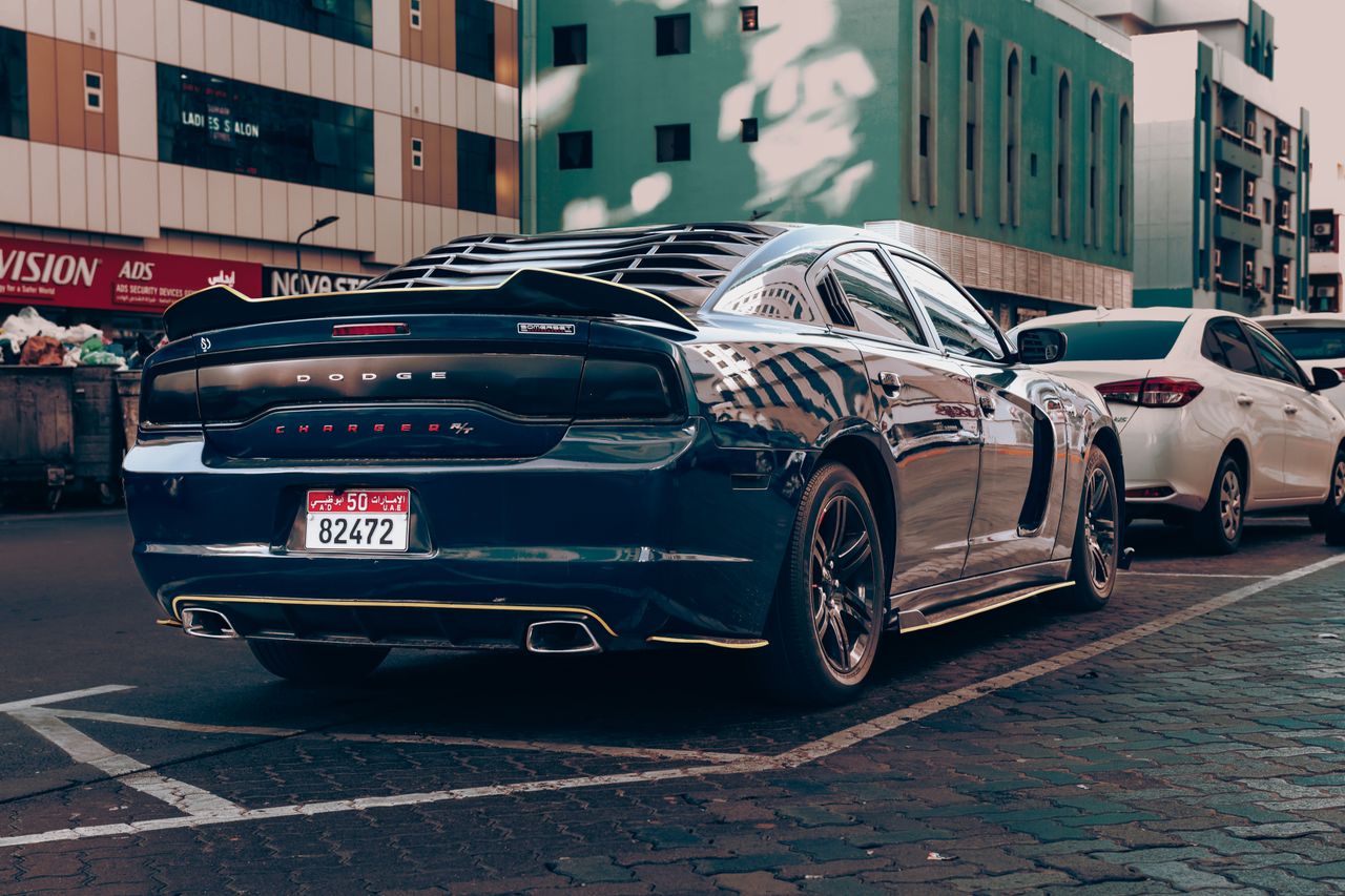 team-03 Luxury Dodge Charger parked in an urban Abu Dhabi setting, showcasing wealth and style.